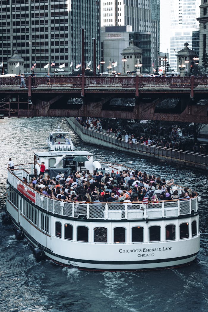 A scenic boat tour navigating Chicago River surrounded by iconic skyscrapers.